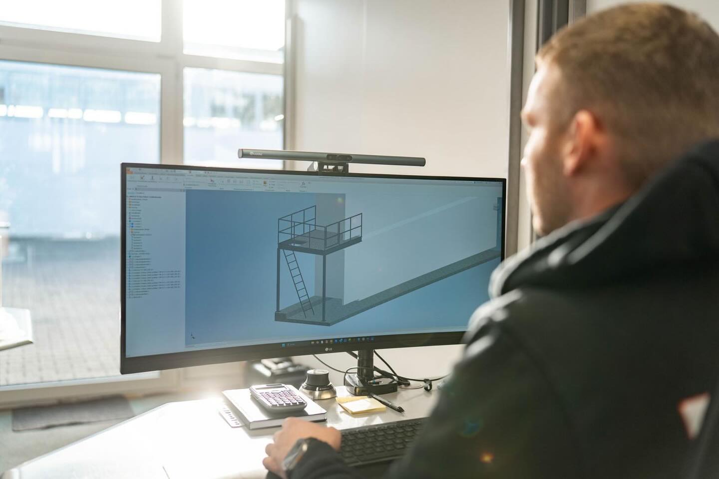 Ein Mitarbeiter plant am Bildschirm ein 3D-Modell.